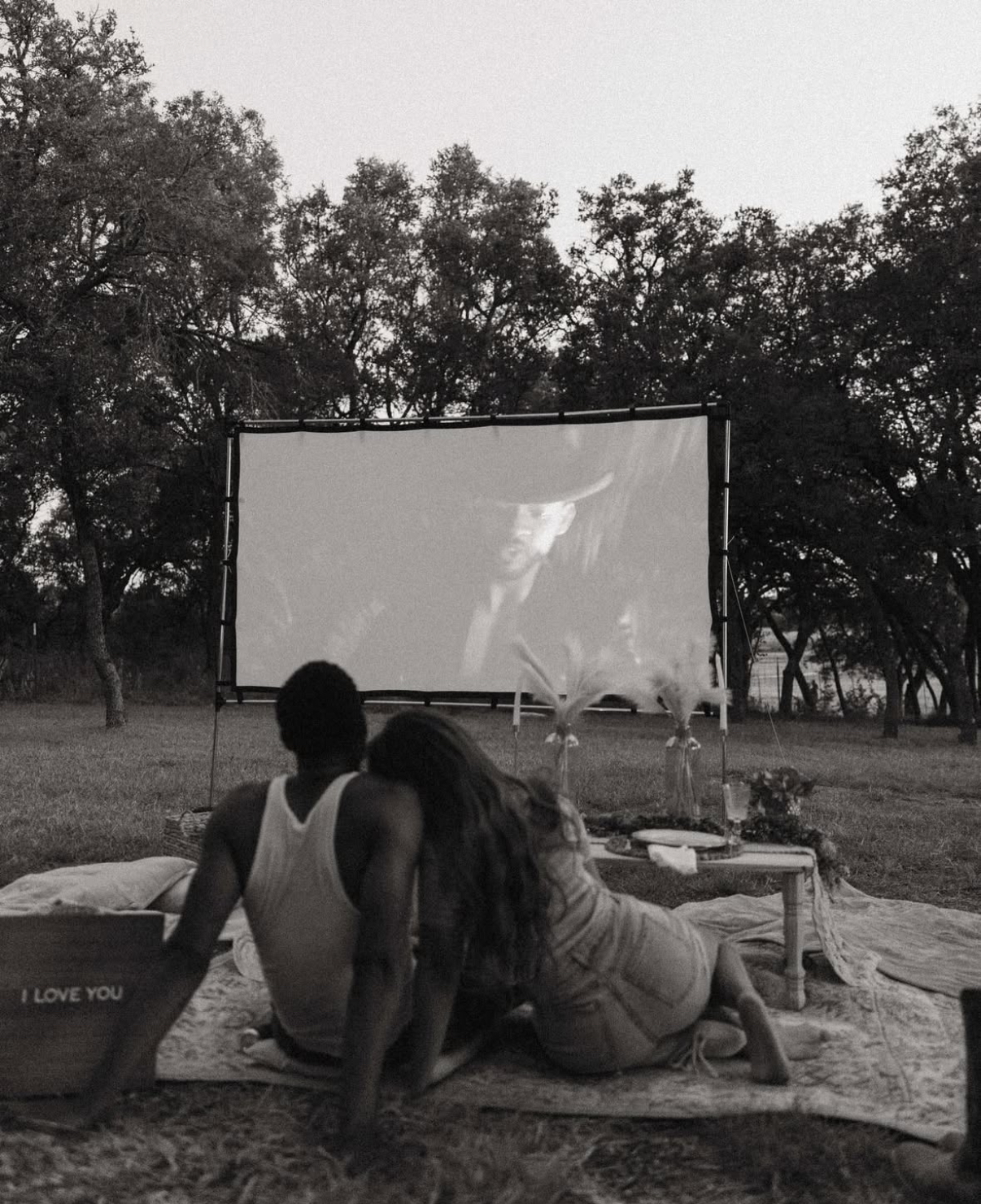 Couple enjoying a romantic movie night outdoors