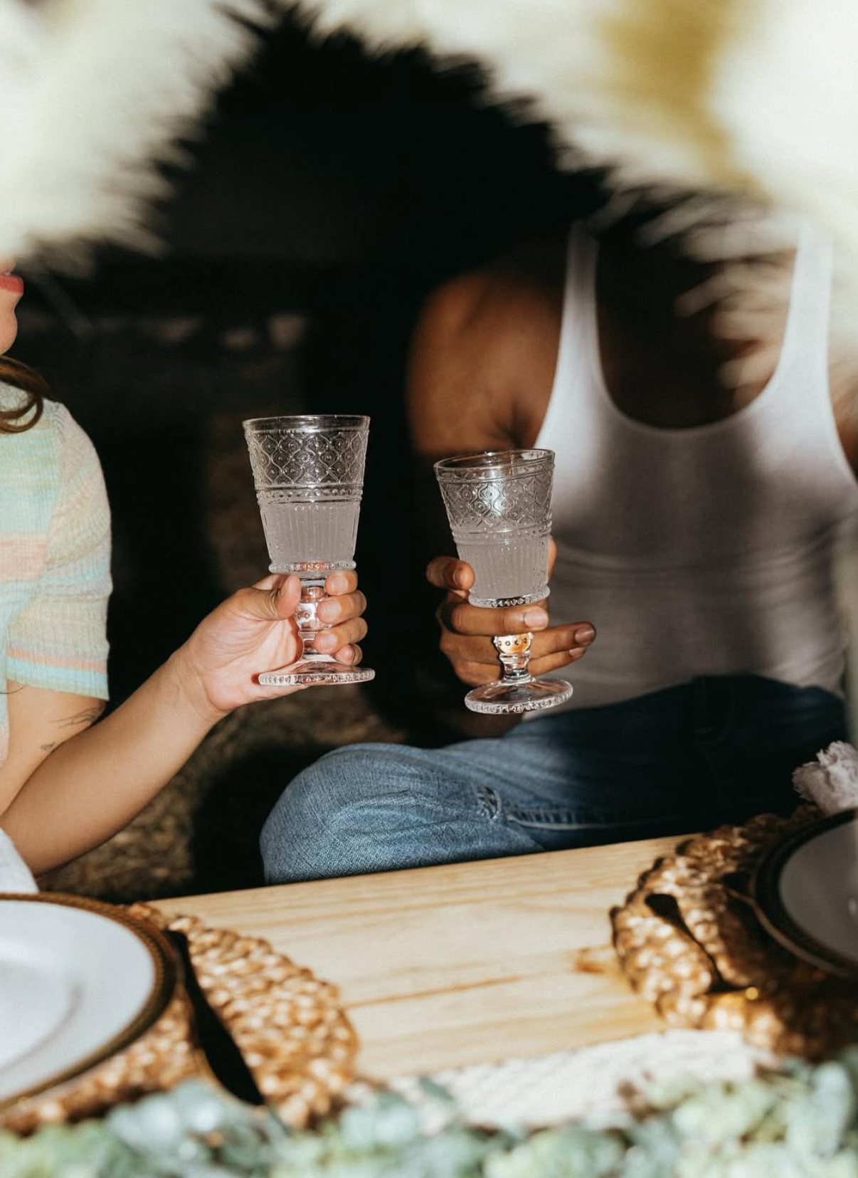 A toast with beautiful glassware at a movie night picnic